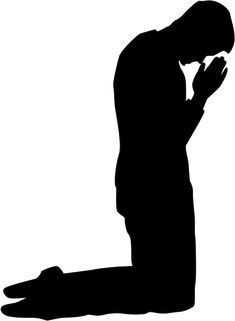 the silhouette of a man kneeling and praying