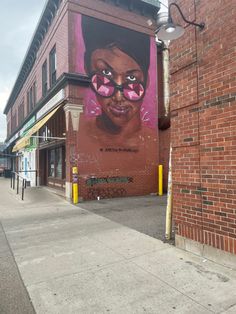 a brick building with a mural on it's side