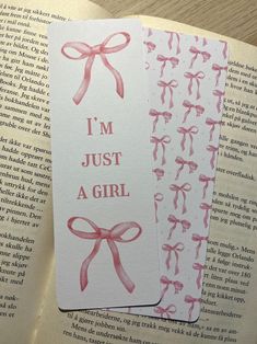 two bookmarks that say i'm just a girl with pink bows on them