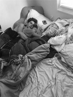 black and white photograph of a man laying in bed