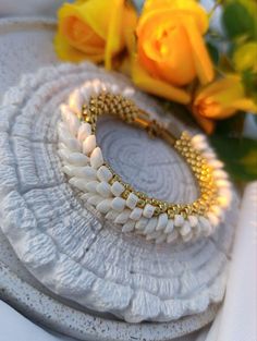 💎Add a touch of elegance to your outfit with this stunning silver and beige beaded bracelet. Each bead is carefully crafted and strung together to create a unique and sophisticated piece that will effortlessly elevate your look.                                                                                                                 💎COLOR: Beige, gold 💎MATERIAL: Japanese beads toxo, long magatama, stainless steel 🔸 The width of the crochet bracelet is 1 centimeter ( 0.39 Inches). 🔸Br Handmade Pearl Crystal Bracelet, Unique Hand-strung Gold Beaded Bracelets, Elegant Beaded Braided Bracelets, Elegant Beaded Braided Bangle Bracelet, Elegant Beaded Bangle Bracelets, Handmade Pearl White Beads For Gifts, Hand-strung Beige Bracelet Jewelry, Elegant Gold Hand-strung Crystal Bracelet, Handmade White Beads For Festive Occasions