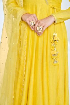 Bright yellow soft chanderi angrakha anarkali with aari, pita and mukaish embroidered neckline. Comes with pant and a dupatta.
Components: 3
Pattern: Embroidered
Type Of Work: Aari, Pita, Mukaish
Neckline: V Neck
Sleeve Type: Full
Fabric: Anarkali: Soft chanderi, Pant: Cotton stretch, Lining: Chanderi
Color: Yellow
Other Details: 
Attached lining
Length:
Anarkali: 52 inches
Sleeves: 23 inches
Pant: 38 inches
Dupatta: 2.5 mtrs
Occasion: Mehendi and Haldi - Aza Fashions Festive Long Lehenga With Dori Work, Semi-stitched Long Anarkali Set With Dori Work, Long Semi-stitched Anarkali Set With Dori Work, Long Kurta With Dori Work For Festive Occasions, Long Dupatta With Dori Work For Eid, Festive Long Dupatta With Dori Work, Anarkali Lehenga With Dori Work, Festive Long Kurta With Dori Work, Designer Long Choli With Sheer Dupatta