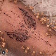 a tattoo on the back of a woman's leg with birds flying over it