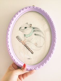 a person holding up a plate with a drawing of a squirrel on it's side