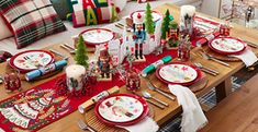 a christmas table setting with red and white plates