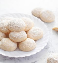 powdered sugar cookies on a white plate