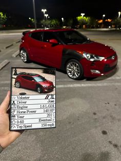 a person holding up a card with a car parked in the parking lot behind them