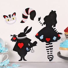 there are some cupcakes that have been decorated with alice and the wonderland characters