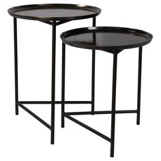 two black tables with metal legs and one has a tray on the top, while another is