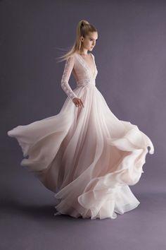 two beautiful women in long dresses posing for the camera