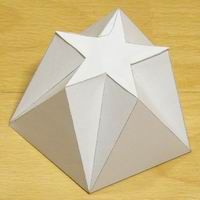 an origami star on a wooden surface