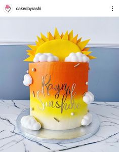 a cake that has been decorated to look like a sun and clouds on top of it