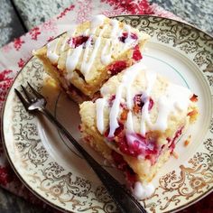 two pieces of cake sitting on top of a white and red plate with a fork