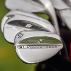 several different types of golf irons and driver's clubs in close up view