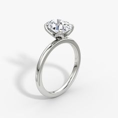 a white gold engagement ring with a pear shaped diamond