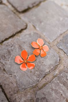 Bold orange and golden statement earrings that feature a vibrant flower pendant that is composed of high-quality stainless steel ensuring it to be a forever piece. Our models also wear the Adexa dress, Georges shirt, and Maddie jeans Elegant Orange Jewelry For Spring, Elegant Orange Spring Jewelry, Orange Flower Earrings For Gift, Summer Orange Flower-shaped Jewelry, Orange Earrings For Spring Gift, Spring Gift Orange Earrings, Orange Flower Shaped Earrings For Summer, Orange Flower-shaped Earrings For Summer, Orange Flower Earrings For Spring