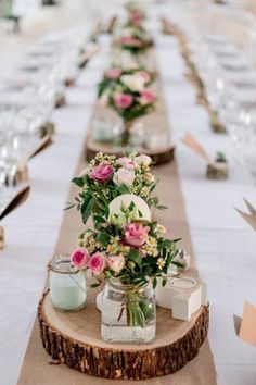 a long table with flowers and candles on it