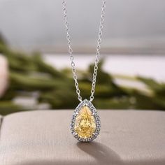 Center Stone: 10*7 mm (2.3 Ct) Approx. Pear Yellow Sapphire Lab Simulated Diamond Halo: Round Cut Moissanite Diamond of 1.1mm Each. Chain Length: 20 Inches, can be Customise As Per Request. ● If you don't find your perfect moissanite or Jewelry in our listing, just start a conversation or send us a photo, we will make your desire jewelry in no time. ● Send us the picture or discuss with us regarding the Jewelry you want, and we will craft it for you. ● We at Gem Of Jewel happily accept jewelry c Pear Diamond Necklace, Halo Necklace, Cable Chain Necklace, Necklace For Her, Round Moissanite, Pear Diamond, Yellow Sapphire, Diamond Halo, Moissanite Diamonds