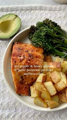 a white plate topped with meat, potatoes and broccoli next to an avocado