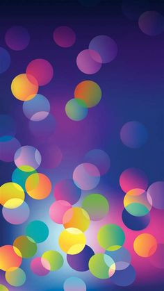 an abstract background with colorful circles and blurry lights in the dark blue, pink, green, yellow, orange