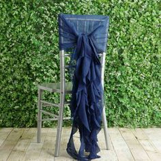 a chair with a blue ruffled seat cover on it next to a green wall