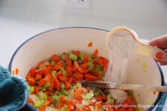 someone is grating carrots and celery into a bowl