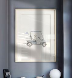 a golf cart is framed in a gray wall above a white table with two cups on it