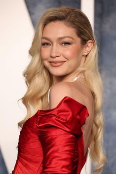 a woman with long blonde hair wearing a red dress