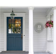 a blue front door on a white house