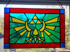 a stained glass window with a bird in the center and sunburst on it