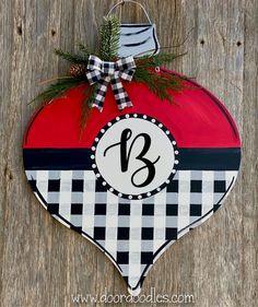 a heart shaped ornament with the letter b in black and white checkerboard