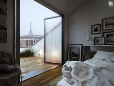 a bedroom with a view of the eiffel tower in the distance and pictures on the wall