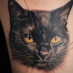 a black cat with yellow eyes is on the side of a woman's thigh