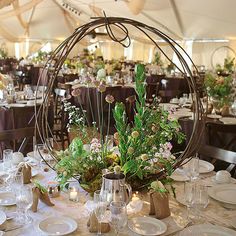 the table is set with white plates and flowers