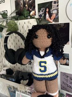 a crocheted stuffed animal with a number on it's shirt and shorts