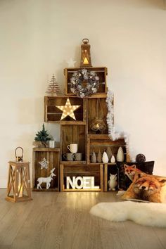 there is a christmas tree made out of wooden crates with decorations on top and below