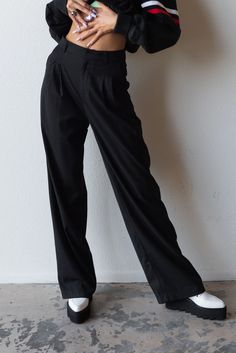 Meet your new favorite pants. Timeless and trendy are the Perfect Trouser featuring a loose fit with front pleat detail and side pockets. Color: Black Loose Fit Front Pleats Pockets Wide Leg Mid Rise Rayon Blend Model is 5'10", size 25/26 in bottoms and is wearing size small Business Casual Wide-leg Pleated Pants, Chic Relaxed Fit Cargo Pants For Work, Black Cargo Pants With Welt Pockets For Fall, Black Cotton Office Pants, Black Baggy Bottoms For Formal Occasions, Tailored Black Pants With Side Pockets, Black Business Casual Dress Pants With Side Pockets, Black Cotton Office Bottoms, Black Dress Pants With Side Pockets For Business Casual