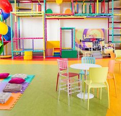 colorful children's playroom with lots of furniture and accessories on the floor,