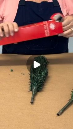 someone is making fake grass out of scissors