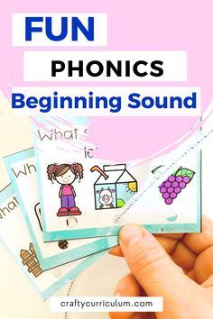 a hand holding four cards with the words fun phonics beginning sound