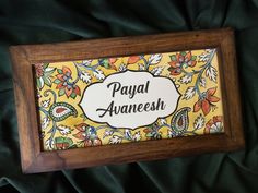 a wooden frame with an ornate design on it that says payal aaneesh