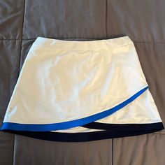 Rlx Golf Skirt White With Blue Cross Over Detail Side Zip Pockets Built In Hidden Shorts With Additional Pockets Nwt! Size M Blue Tennis Skort For Spring, Casual White Swim Skirt For Sports, White Tennis Skirt With Lining, White Swim Skirt For Tennis In Spring, White Lined Sports Skirt, Blue Sporty Tennis Skirt, White Sports Skirt For Spring, Spring Sports White Skirt, Casual White Tennis Swim Skirt