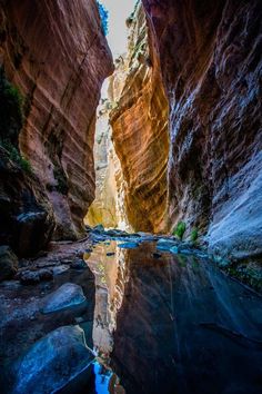 a narrow river in the middle of a canyon