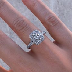 a woman's hand with a diamond ring on it and an engagement band around her finger