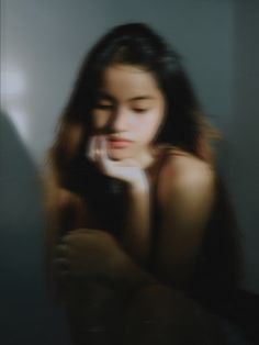 a woman with long hair brushing her teeth