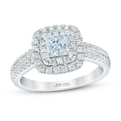 a white gold engagement ring with a princess cut diamond center surrounded by round brilliant pave diamonds