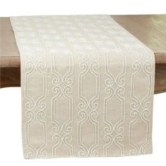 a white table runner on top of a wooden table