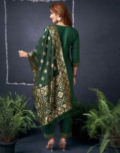 Dark Green Cotton Sequence Straight Kurta Set With Dupatta  Dark Green Cotton Sequence Straight Kurta Set With Dupatta is a glamorous and sparkling ensemble. The intricate sequence work, often arranged in floral motifs or geometric patterns, adds a dazzling shimmer to the kurta. The straight cut provides a modern and streamlined silhouette, while the accompanying dupatta can be styled in various ways to complete the look.  Features Of Dark Green Cotton Sequence Straight Kurta Set With Dupatta  T Elegant Celebration Sets For Navratri, Art Silk Churidar For Celebration, Elegant Green Sets For Festivals, Green Banarasi Silk Party Sets, Elegant Unstitched Sets With Motifs, Festive Fitted Dupatta With Motifs, Elegant Sets With Motifs And Traditional Drape, Designer Gold Sets With Motifs, Banarasi Silk Churidar For Festive Occasions