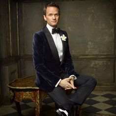 a man in a tuxedo sitting on a bench