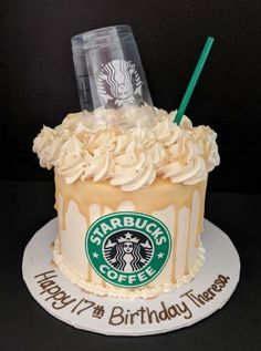 there is a starbucks cake with whipped cream on top and a starbucks cup in the middle